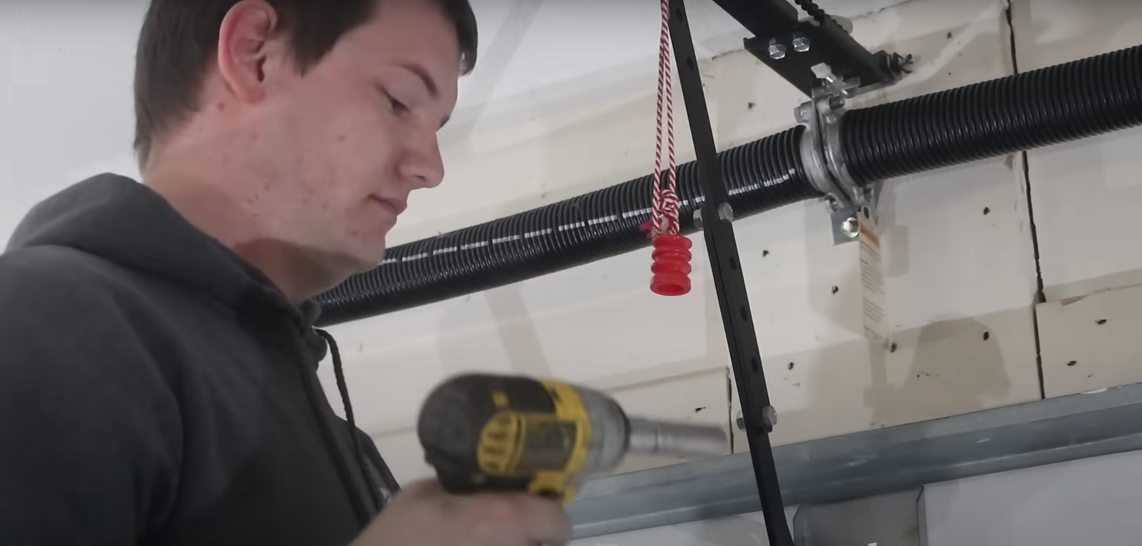 Expert in Columbus Ohio repairing garage door spring.